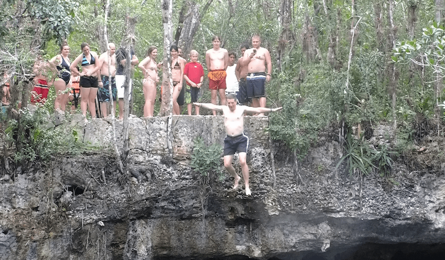 Tom jumps off a cliff with Percona colleagues in Cancun, 2011